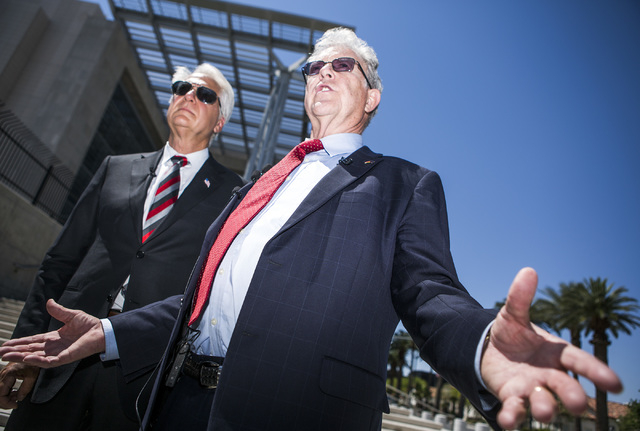 Attorneys Larry Klaymam, left, Joel Hansen, representing Nevada rancher Cliven Bundy, talks to the media in front of Lloyd George U.S. Courthouse after filing a lawsuit  against President Barack O ...
