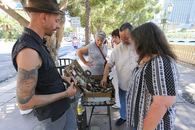 Christopher Reitmaier, left, makes jewelry from reclaimed objects in front of the Bellagio hotel-casino on the Strip in Las Vegas on Friday, May 27, 2016. (Brett Le Blanc/Las Vegas Review-Journal) ...