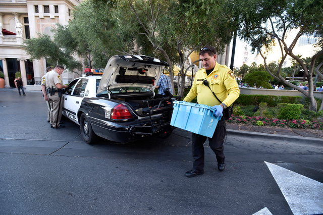 Las Vegas police officer Pierre Hutchings carries a container of water as evidence before it is transported to the newly opened Civil Diversion Program facility just off the Las Vegas Strip Friday ...
