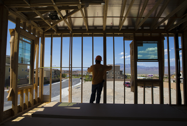 Jose Juarez measures a wall panel in a three-story home being constructed in the newly-developed Skye Canyon community, Monday, May 23, 2016, in Las Vegas. Benjamin Hager/Las Vegas Review-Journal