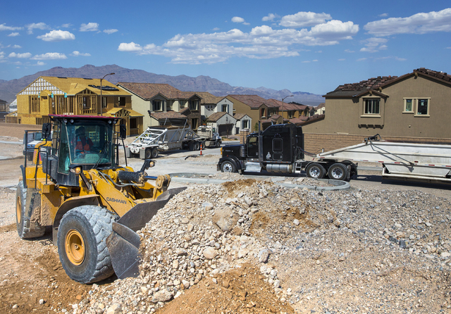Construction workers clear space for an empty lot in the newly-developed Skye Canyon community, Monday, May 23, 2016, in Las Vegas. Benjamin Hager/Las Vegas Review-Journal