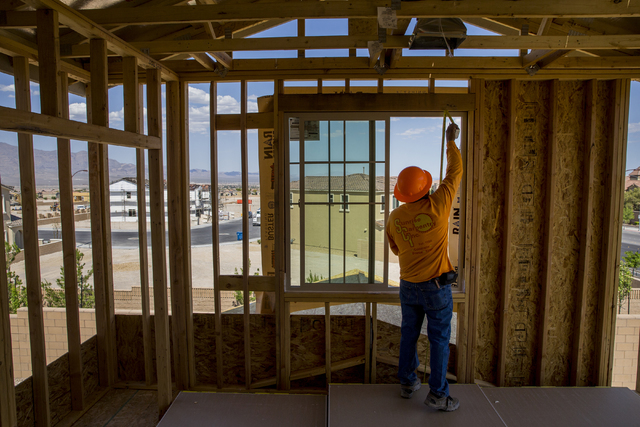 Jose Juarez measures a wall panel in a three-story home being constructed in the newly-developed Skye Canyon community, Monday, May 23, 2016, in Las Vegas. Benjamin Hager/Las Vegas Review-Journal