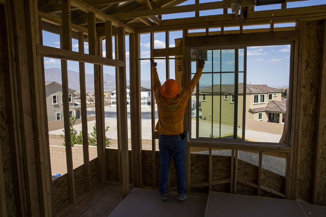 Jose Juarez measures a wall panel in a three-story home being constructed in the newly-developed Skye Canyon community, Monday, May 23, 2016, in Las Vegas. Benjamin Hager/Las Vegas Review-Journal