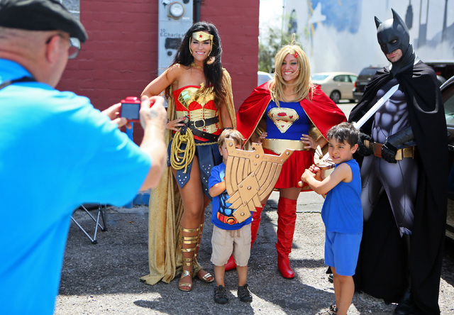 From left, Lara Duffin, dressed as Wonder Woman, stands with Ben Foster, 3; Tia Golden, dressed as Supergirl; Joe Foster, 5, and Cody Strohl, dressed as Batman, for a personal photograph during a  ...