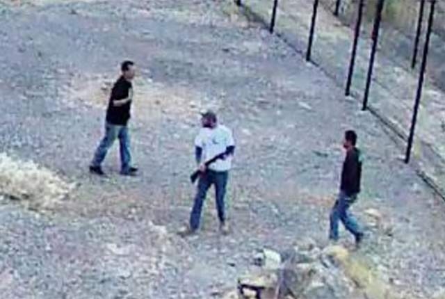 Surveillance footage shows three men, at least one with a gun, who broke into the endangered fish habitat at Devils Hole, 90 miles west of Las Vegas, on April 30. (National Park Service)
