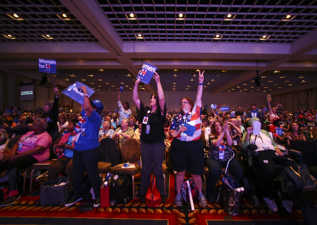 Supporters of Democratic presidential candidate Hillary Clinton react as a video is played during the Nevada State Democratic Party's 2016 State Convention at the Paris hotel-casino in Las Vegas o ...