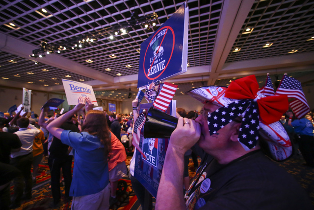 Matthew Gibmeyer, right, chants "this is fixed" with supporters of Democratic presidential candidate Bernie Sanders during the Nevada State Democratic Party's 2016 State Convention at the Paris ho ...