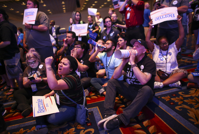 Supporters of Democratic presidential candidate Bernie Sanders, including Valeria Romano, center left, and Johnny Hancen, center right, gather in the front of the room during the Nevada State Demo ...
