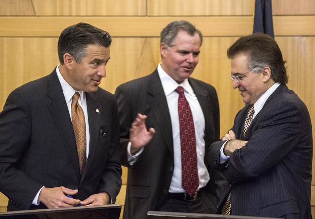 Nevada Gov. Brian Sandoval, left, Jim Murren, CEO of MGM Resorts International, and Tony Alamo, chairman of Nevada Gaming Commission, talk during the Gaming Policy Committee meeting at the Clark C ...