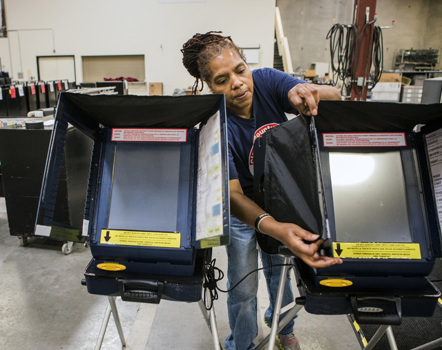 Program assistant Connie Sneed sets up voting machines during a training session at the Clark County Elections Department warehouse, 965 Trade Drive, North Las Vegas, on Thursday, May 12, 2016. Je ...