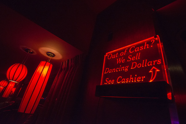 A sign points to where to get "Dancing Dollars" at Girls of Glitter Gulch in downtown Las Vegas on May 24, 2016. (Bridget Bennett/Las Vegas Review-Journal) Follow @bridgetkbennett