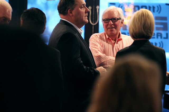 Bill Foley talks to Steve Eanes, left, a member of the Founding 75, at an event to promote season ticket sales for a potential NHL franchise Tuesday, March 24, 2015 at Born and Raised bar. (Sam Mo ...