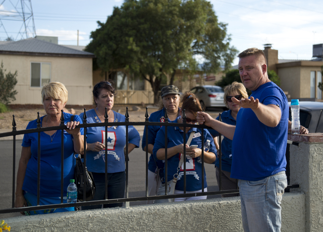 Retired Sgt. Maj. Robert Brown speaks with members of the Blue Star Mothers of Henderson and Boulder City outside the home of Marina Vance where he and volunteers cleaned and landscaped her yard o ...