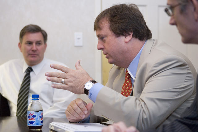Gary Loveman, chairman, CEO and president of Harrah's Entertainment, Inc., center, speaks during an interview at Bally's, Wednesday, August 22, 2007.  At left is Timothy J. Leiweke, president and  ...