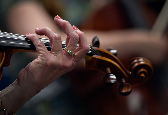 A woman's hand works the fingerboard on a viola during a Henderson Symphony Orchestra rehearsal at Greenspun Junior High School May 2, 2016. David Becker/View