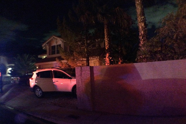 Police investigate the scene on the 2900 block of Setting Sun Street where a man crashed a car into a dividing wall after stealing it from another home. (Thomas Moore/Las Vegas Review-Journal)