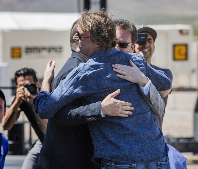 Hyperloop One executives Shervin Pishevar, left, co-founder, executive chairman, Brogan Bam Brogan, chief technology officer, and Rob Lloyd, CEO, congratulate each other after the first public tes ...