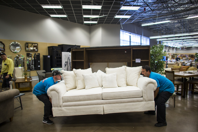 Matt Bernstein, left, and Joseph Del Rio moves a couch in Colleen's Classic Consignment at 5120 S. Fort Apache Road in Las Vegas on Friday, May 6, 2016. Chase Stevens/View Follow @csstevensphoto