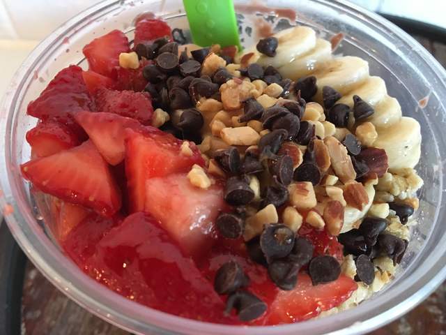 The PB Lover at Acai to the T features acai and pitaya, peanut butter, banana, bee pollen, strawberries and chocolate almond milk and topped with bananas, strawberries, chocolate chips and almonds ...