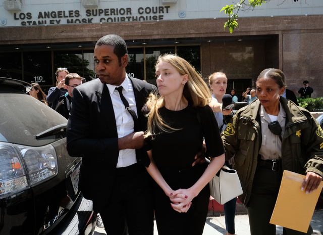 Actress Amber Heard leaves Los Angeles Superior Court court on Friday, May 27, 2016, after giving a sworn declaration that her husband Johnny Depp threw her cellphone at her during a fight Saturda ...