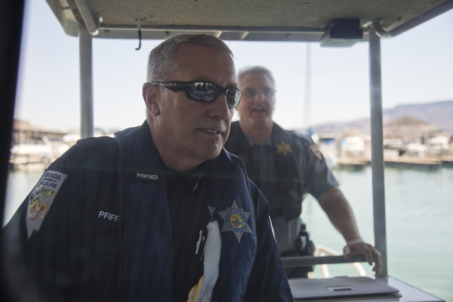 Nevada Department of Wildlife Boating Law Administrator David Pfiffner, left, and Arizona Fish and Game Boating Law Administrator Tim Baumgarten take media out on a boat at Lake Mead on Friday, Ma ...