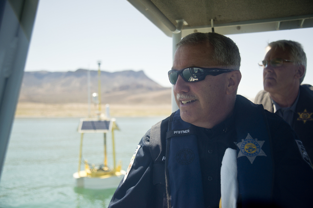 Nevada Department of Wildlife Boating Law Administrator David Pfiffner, left, and Arizona Fish and Game Boating Law Administrator Tim Baumgarten drive a boat near one of the new weather buoys in L ...