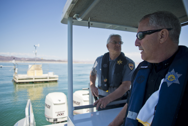 Nevada Department of Wildlife Boating Law Administrator David Pfiffner, right, and Arizona Fish and Game Boating Law Administrator Tim Baumgarten drive a boat near one of the older weather buoys i ...