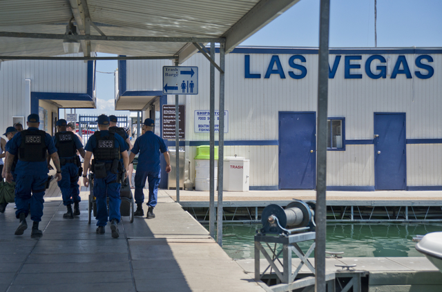 U.S. Coast Guard officers head toward the Government Dock at the Las Vegas Boat Harbor at Lake Mead on Friday, May 27, 2016. The coast guard will have a presence at Lake Mead during Labor Day week ...