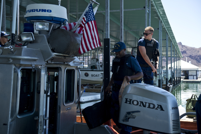 U.S. Coast Guard officers Patrick Dixon, left, and Jacob "Salty Dog" Salts load a boat at the Government Dock at the Las Vegas Boat Harbor on Lake Mead on Friday, May 27, 2016. The coast guard wil ...
