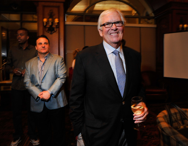 Bill Foley, right, the public face of an ownership group seeking to create an NHL team in Las Vegas, appears during a promotional stop to sell season hockey tickets at the Southern Highlands Golf  ...
