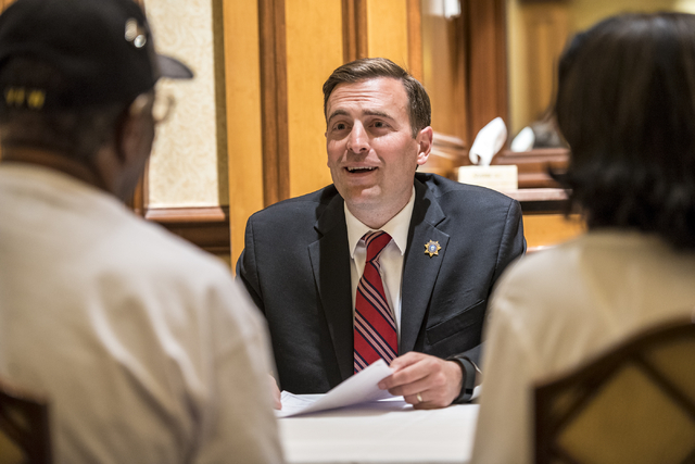 Adam Laxalt, Nevada attorney general, works with James Dorsey and Doris Haynes and assists them with their will during a military appreciation event at the Texas Station hotel-casino in Las Vegas  ...