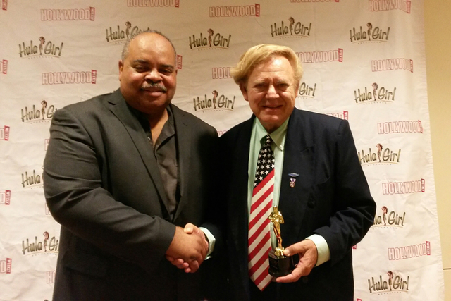 Prather Jackson, left, president of the Hollywood Weekly magazine Film Festival, presents the Honorable Mention Award to Chuck N. Baker for his documentary "Veterans: A Motion Picture." L.F.Guiffr ...