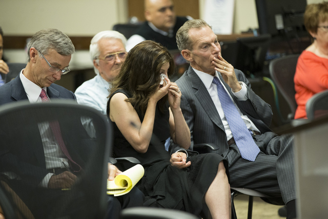 Audience members react to the Board of Regents voting to approve an early retirement deal with Chancellor Dan Klaich during a special meeting at the Nevada System of Higher Education offices on Th ...
