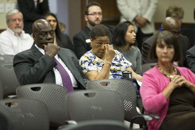 Audience members react to the Board of Regents voting to approve an early retirement deal with Chancellor Dan Klaich during a special meeting at the Nevada System of Higher Education offices on Th ...