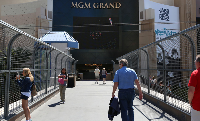 Tourists walk on the pedestrian bridge where a man was stabbed between New York-New York and the MGM Grand Wednesday, May 11, 2016. (Bizuayehu Tesfaye/Las Vegas Review-Journal Follow @bizutesfaye)