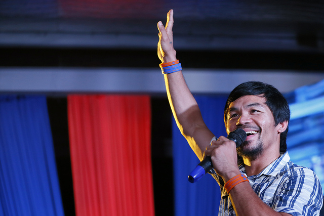 Boxing star Manny Pacquiao addresses supporters as he campaigns for a seat in the Philippine Senate, on Thursday, April 28, 2016 at San Pablo city, Laguna province south of Manila, Philippines. (B ...