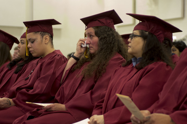 Inmate Karen Bodden wipes tears from her eyes prior to receiving her high school diploma during Florence McClure Women's Correctional Center's graduation ceremony in Las Vegas on May 25, 2016. (Br ...