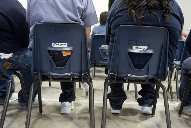 Inmates watch fellow inmates receive their diplomas during Florence McClure Women's Correctional Center's graduation ceremony in Las Vegas on May 25, 2016. (Bridget Bennett/Las Vegas Review-Journa ...