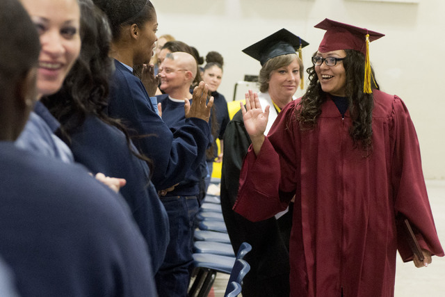 Patricia Aguinaga high-fives another inmate after she receives her high school diploma during Florence McClure Women's Correctional Center's graduation ceremony in Las Vegas on May 25, 2016. (Brid ...