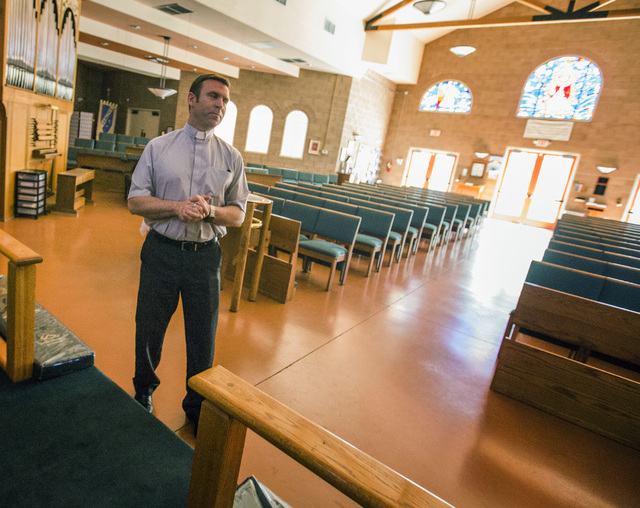 Rev. Michael Engfer stands inside All Saints Episcopal Church, 4201 W. Washington Ave., on Wednesday, May 4,2016. Engfer, serves both All Saints Episcopal Church and the Air Force Reserves as a ch ...