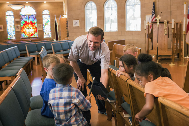 Rev. Michael Engfer performs a magic act with students at All Saints Episcopal Church, 4201 W. Washington Ave., on Wednesday, May 4,2016. Engfer, serves both All Saints Episcopal Church and the A ...