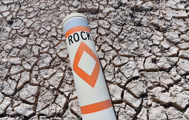A warning buoy lies in the dry earth at the Echo Bay Marina Tuesday, April 26, 2016, at the Lake Mead National Recreation Area. Water officials in Nevada, Arizona and California have negotiated a  ...