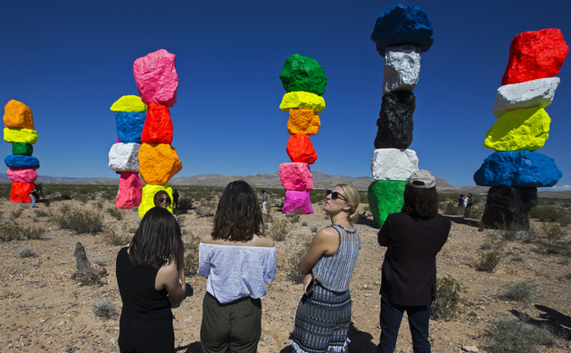 Art Production Fund staffer Shannon Kirk, Kathleen Lynch, Casey Fremont and David B. Walker, executive director of the Nevada Museum of Art, peruse "Seven Magic Mountains," which the fund and muse ...