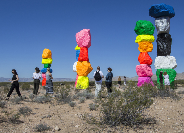 Attendees of a press preview get the first glimpses of the Seven Magic Mountains art project Monday near Jean Dry Lake. Benjamin Hager/Las Vegas Review-Journal