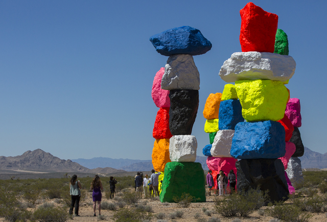 Swiss artist Ugo Rondinone, who wanted to "introduce something artificial in a natural environment," unveils his "Seven Magic Mountains" project in the Jean dry lake bed Monday. Benjamin Hager/Las ...