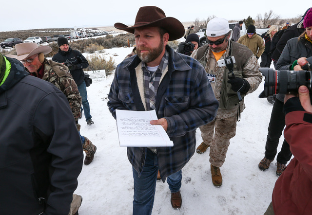Ammon Bundy, center, prepares to speak as he is followed by conservative radio host Pete Santilli at the Malheur National Wildlife Refuge headquarters, occupied by anti-government protesters, near ...
