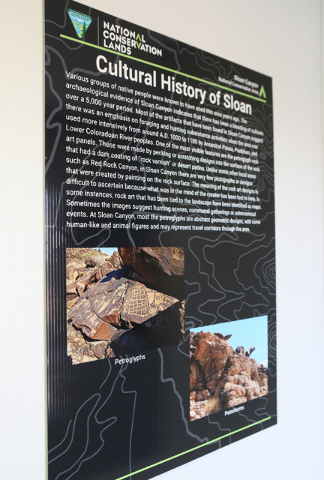 A poster is posted at Sloan Canyon National Conservation's temporary Visitors Center on Thursday, May 19, 2016. The BLM Thursday dedicated the first paved access to the area and other visitor amen ...