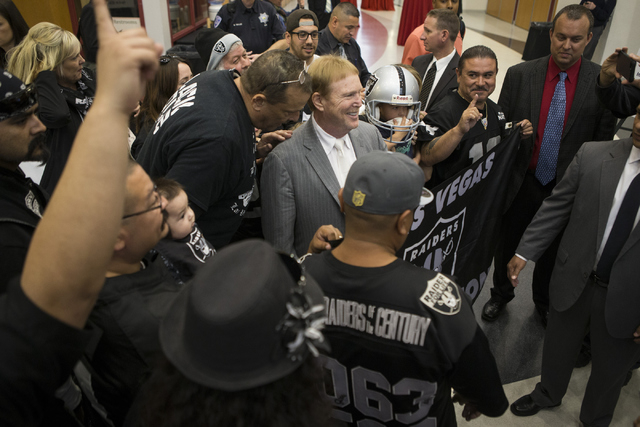 Oakland Raiders owner Mark Davis, center, poses with team fans following press conference on the proposed Las Vegas dome stadium at the Stan Fulton Building at UNLV on Thursday, April 28, 2016, in ...