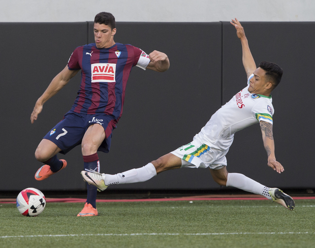 SD Eibar's Ander Capa (7) fights for a ball with New York Cosmos' David Diosa (21) during a friendly between the New York Cosmos and SD Eibar, Wednesday, May 25, 2016, at Sam Boyd Stadium in Las V ...