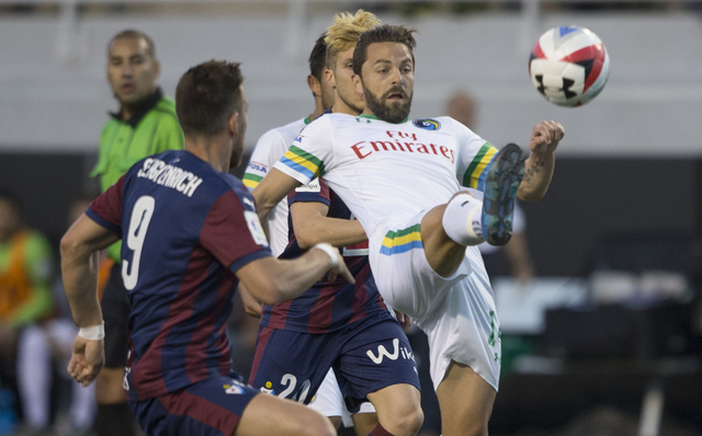 New York Cosmos midfielder Danny Szetela (14) fights for possession with SD Eibar's Sergi Enrich (9) during a friendly between the New York Cosmos and SD Eibar, Wednesday, May 25, 2016, at Sam Boy ...